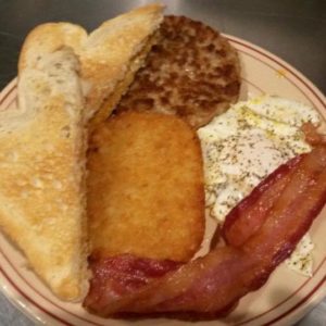 eggs, bacon, toast, sausage, hashbrown on plate