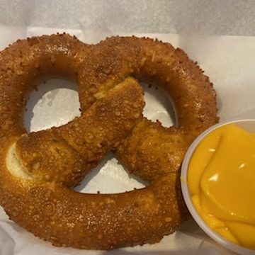Pretzel with cup of cheese